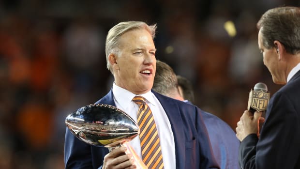 Denver Broncos general manager John Elway holds the Vince Lombardi Trophy after defeating the Carolina Panthers in Super Bowl 50 at Levi's Stadium.
